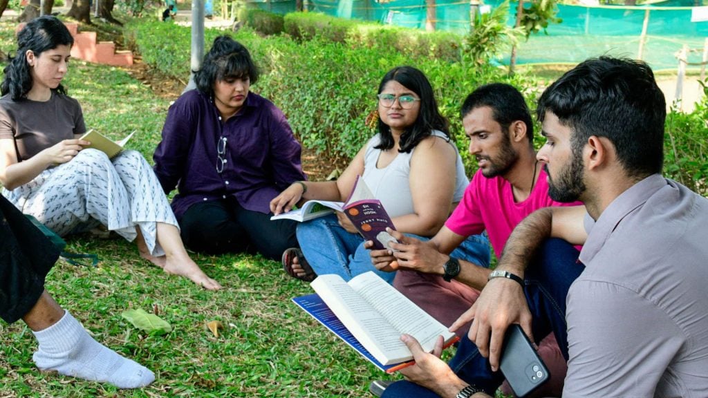A team reading together outdoor- The Sanskaari Girls Book Club | What We Have Been Reading