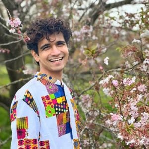 Photo of the curator Anish amidst the backdrop of trees