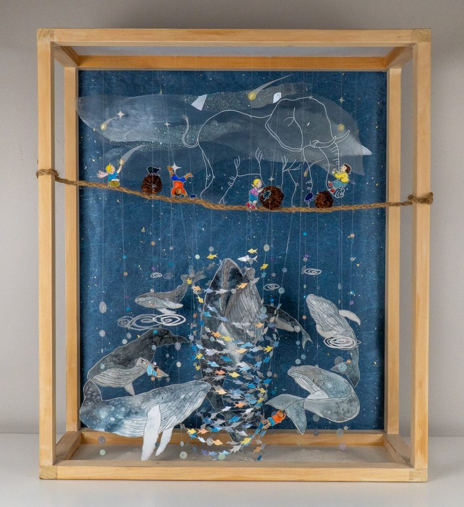 An image of children dancing as an elephant plods along.