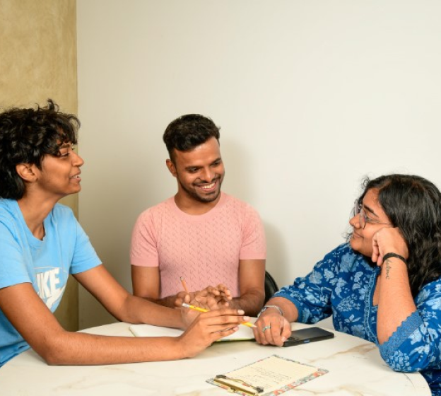 team of 3 people discussing and having a good time