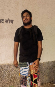 Joshua Fernandes, social justice advocate and PoSH (Prevention of Sexual Harassment) trainer, posing for a professional portrait with a contemplative expression, reflecting his work in community-building and systemic change