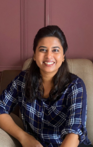 Poornima Menon, social justice professional and One Future Collective fellow, posing for a portrait with a determined expression, symbolizing her work in gender empowerment and feminist leadership